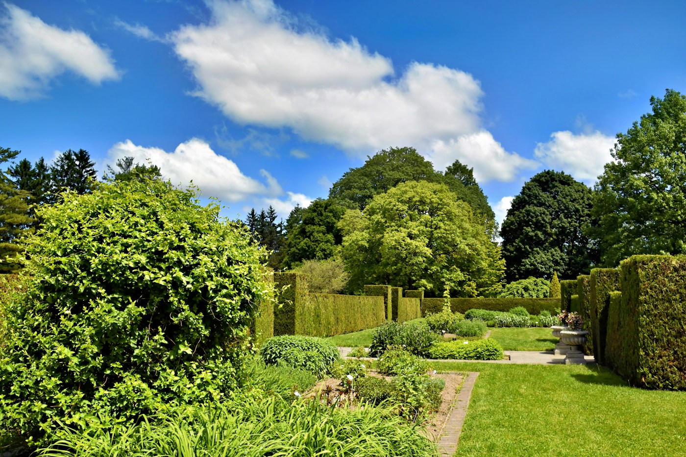 Formal garden with brick paths and carefully trimmed greenery